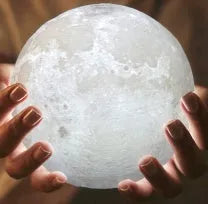 3D printed white moon lamp with textured surface on a wooden stand, showing touch ring at base