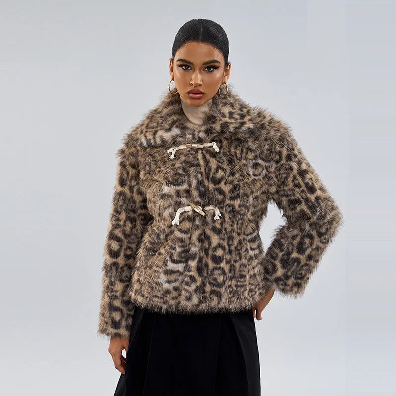 Women's leopard print coat with a buckle lapel closure on a street fashion model.