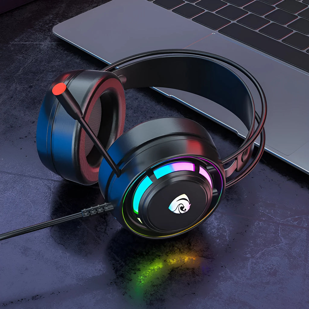Black over-ear wired computer headset with microphone and long cable on a desk.