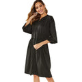 Black mid-length A-line dress with long sleeves and an elastic cinched waist with a loose belt.