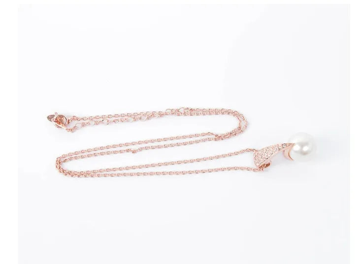 Rose gold alloy bridal necklace and earrings set with pearl inlay and mother-of-pearl pendant on water wave chain