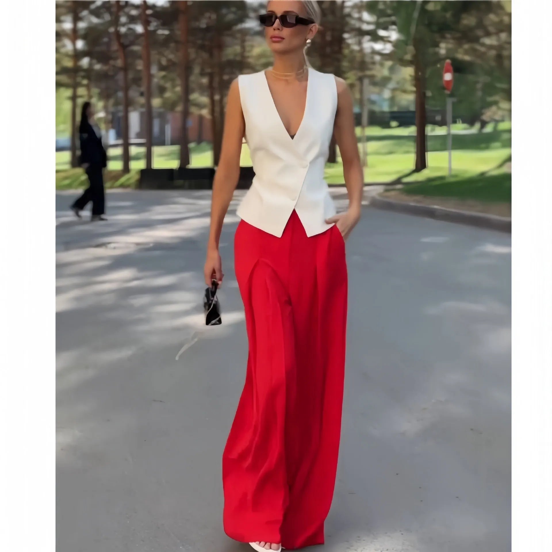 Women's beige two-piece set with sleeveless deep V-neck top and high-waisted wide-leg trousers