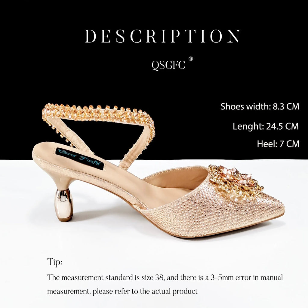 Black high heel ankle strap shoes with floral buckle and matching rhinestone clutch bag.