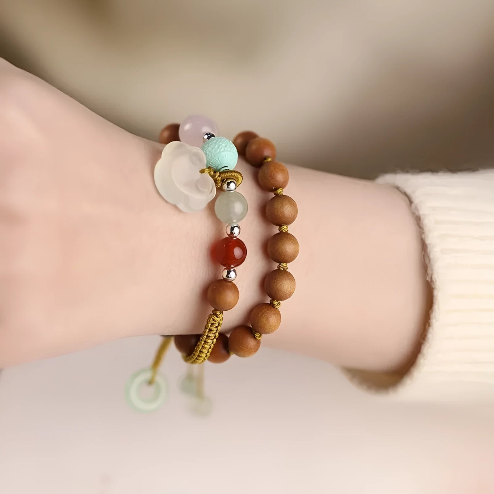 Hand-woven women's sandalwood bracelet with double-ring design and traditional gemstone accents