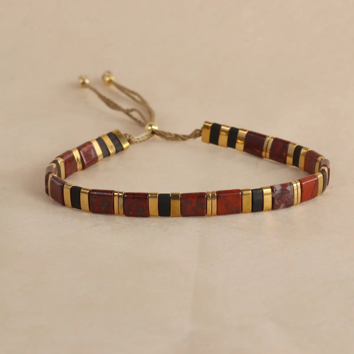 Geometric pull bead bracelet with glass and coloured glaze beads in round design