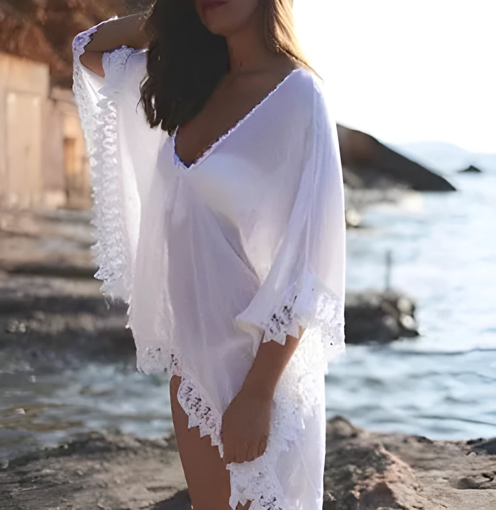White tasselled beach coverup with pom-pom trim, lightweight kaftan style for beach and poolside