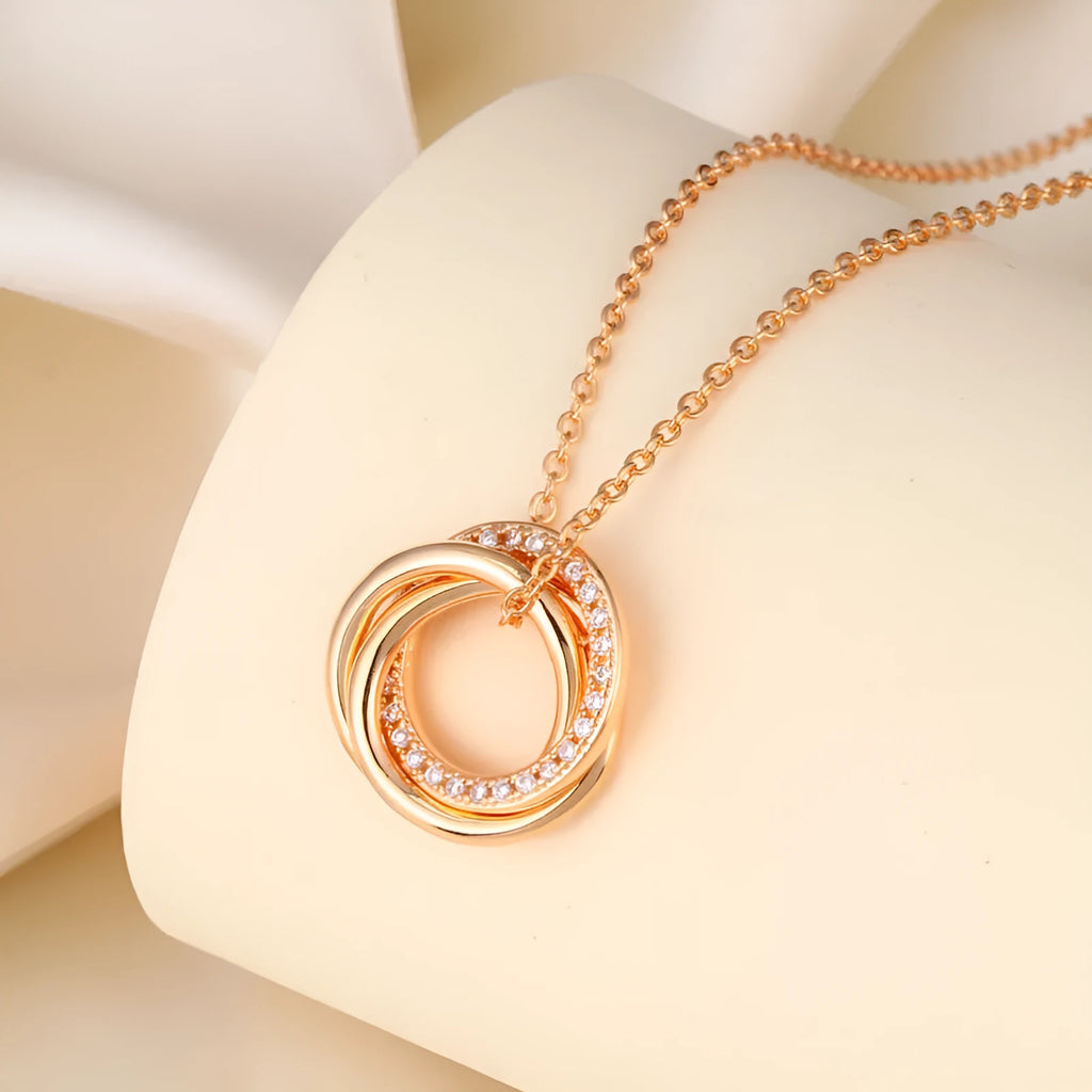 Geometric copper necklace with micro-inlaid interlocking three rings in champagne gold on woman