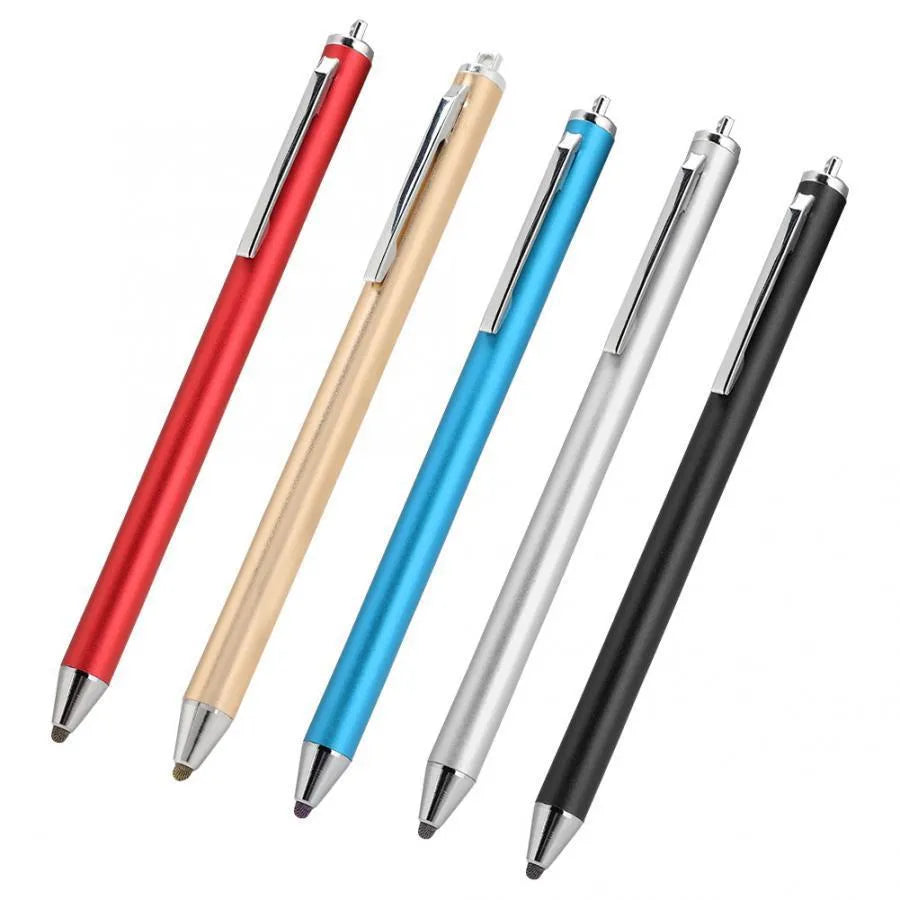 A black metal stylus with a fine point tip positioned next to a mobile phone and tablet on a desk.