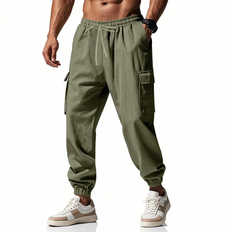 Men's loose-fit linen trousers with ankle ties and a drawstring waist in a solid colour.