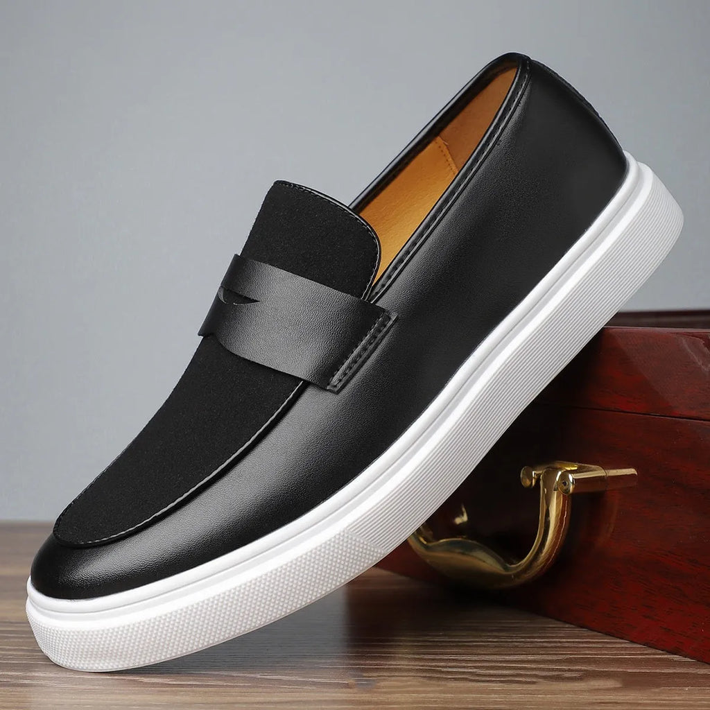 Men's black slip-on casual Gommino-style shoes with round toe and tassel decoration on a flat mid-heel.