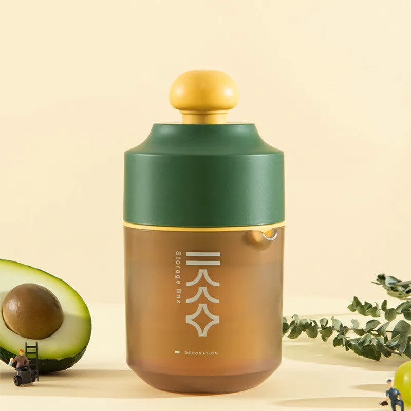 Green manual citrus juicer with lid, showing its compact size and simple design for squeezing lemons and oranges.