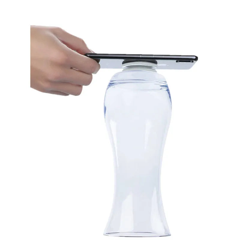 Transparent circular and square silicone nano gel adhesive pads on a car dashboard holding a mobile phone.