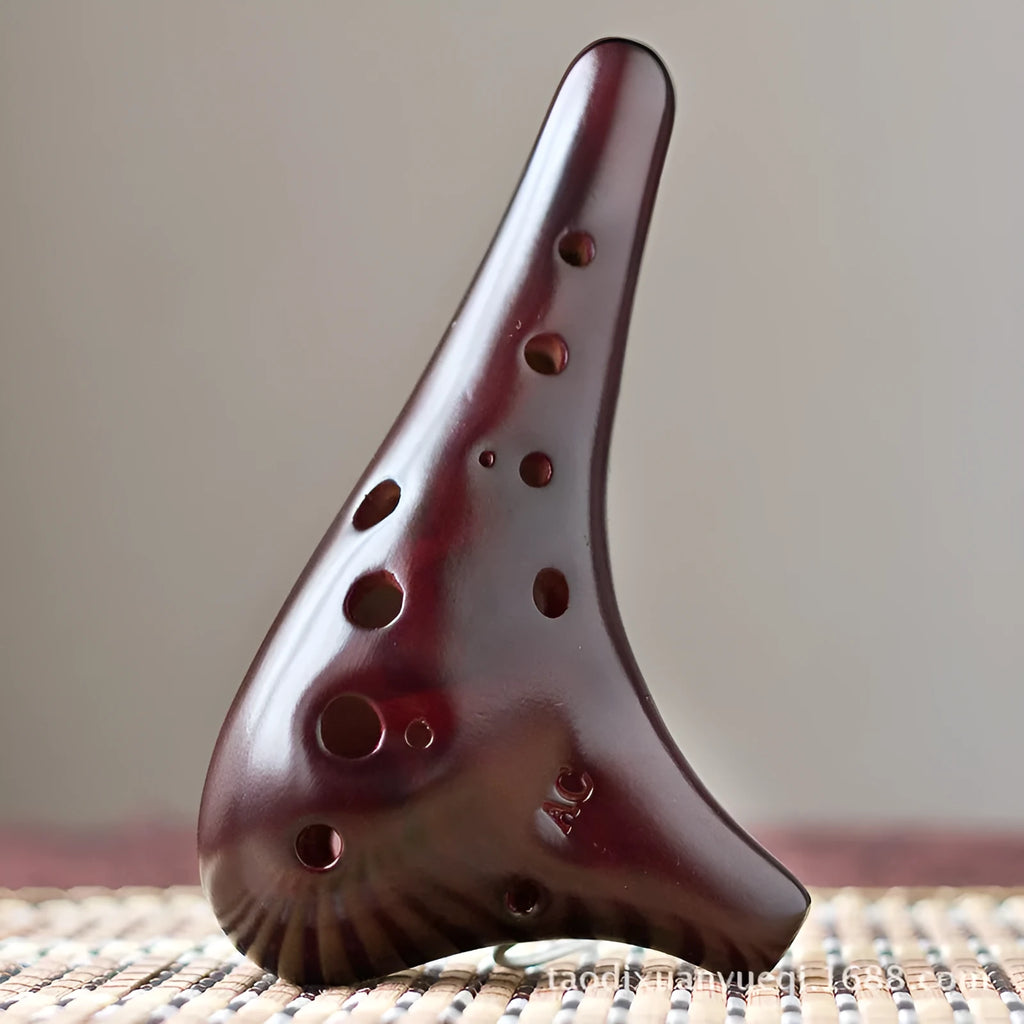 Smoked brown 12-hole dolomite ocarina, 14x8cm, midrange C, with raw lacquer surface.