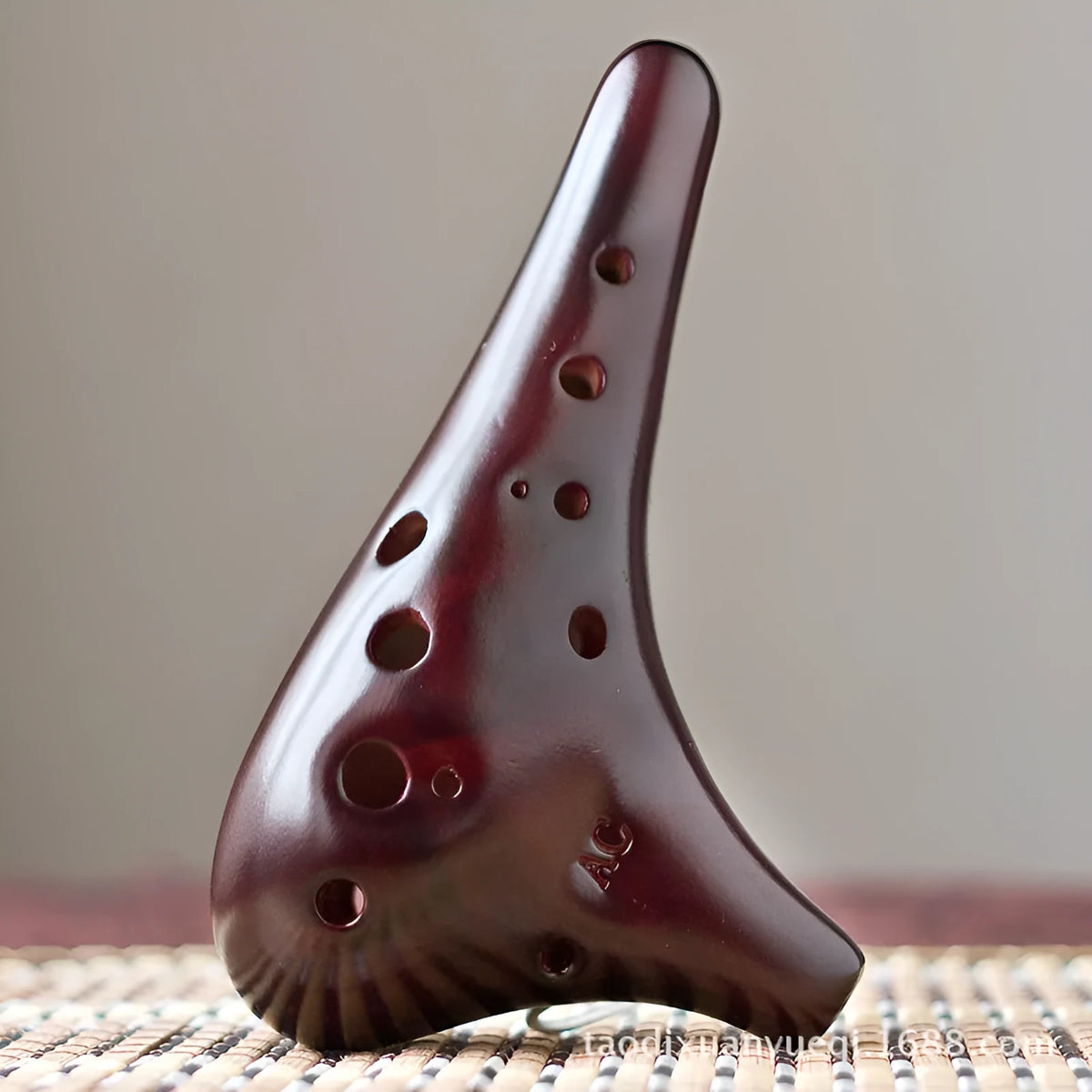 Smoked brown 12-hole dolomite ocarina, 14x8cm, midrange C, with raw lacquer surface.
