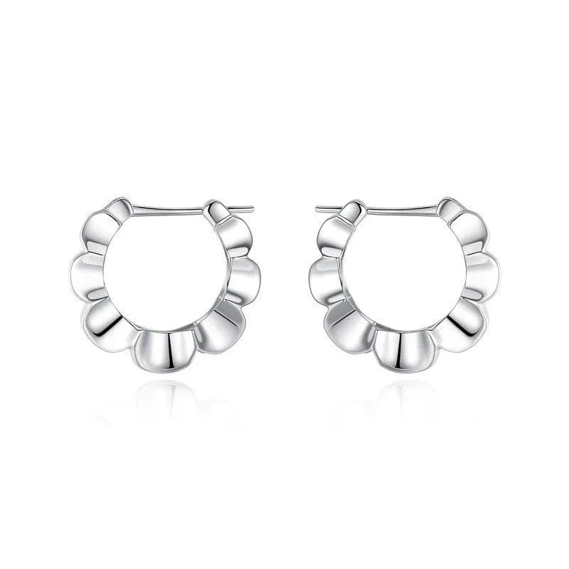 A pair of sterling silver geometric earrings with round accents on a white background.