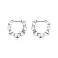 A pair of sterling silver geometric earrings with round accents on a white background.