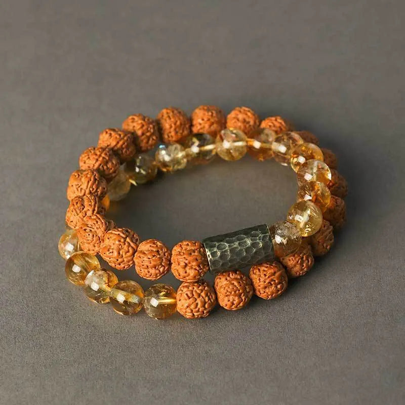 Handmade yellow tower crystal bracelet with double ring design on wrist.