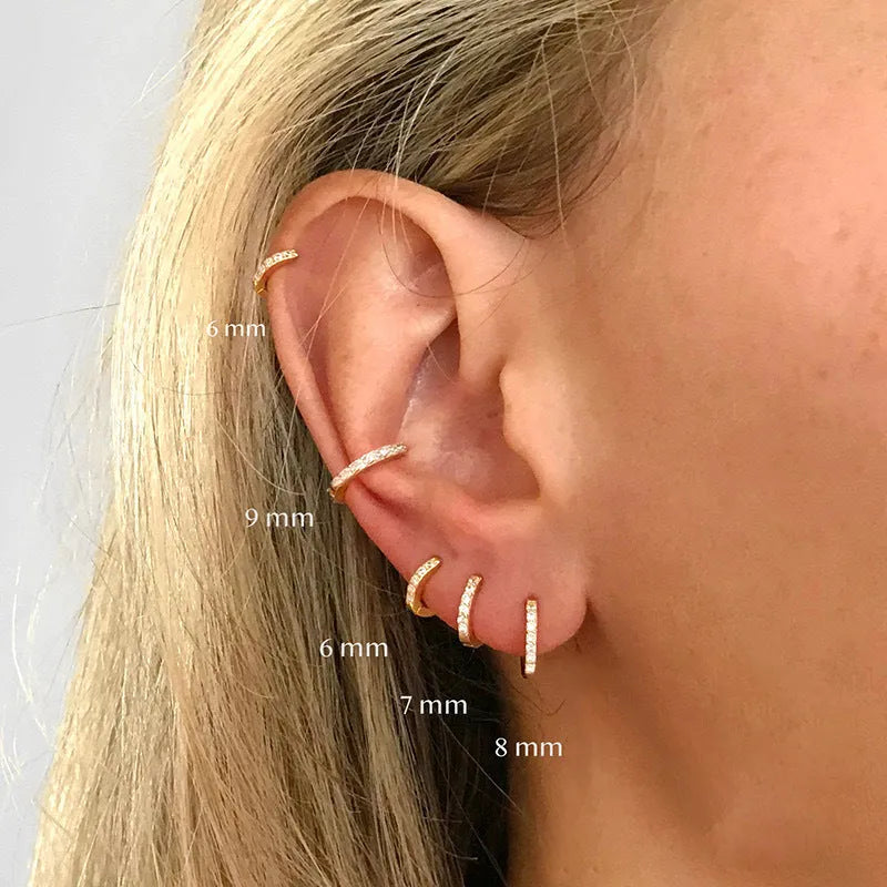 A pair of round geometric circle zircon stud earrings on a plain background, showing gold, rose gold, and silver colour options.