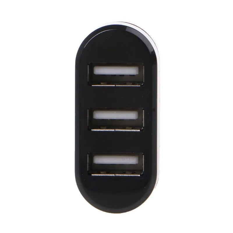 Black or white USB 2.0 four-port hub for laptop expansion on a desk.
