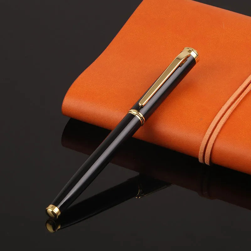 Red and black metal ballpoint pen with a 0.5mm stainless steel nib on a notepad.