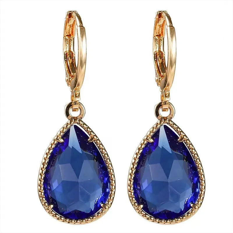 Copper-coloured rare earth metal and glass geometric saturn water drop earrings in multiple colours.