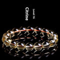 Original design natural citrine scattered bead bracelet on a wrist, showing polished stones in a golden hue.