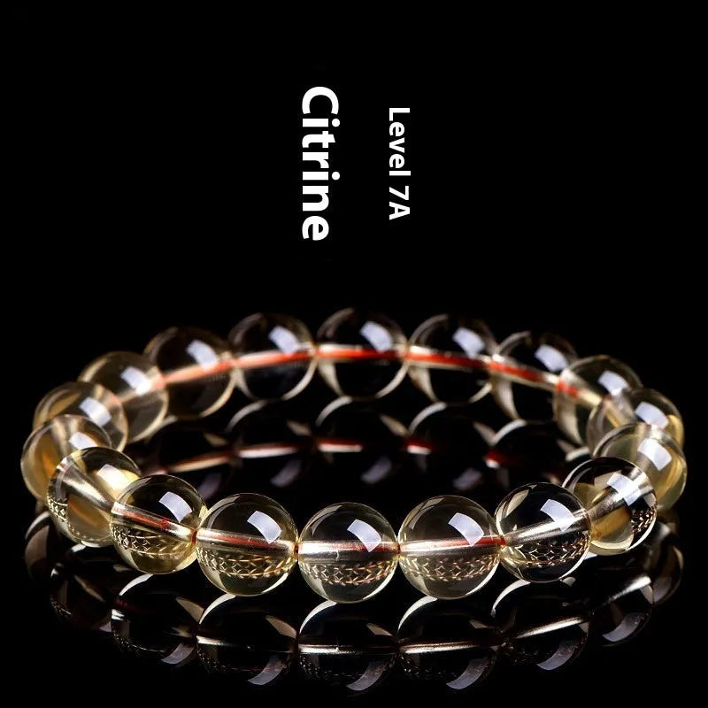 Original design natural citrine scattered bead bracelet on a wrist, showing polished stones in a golden hue.
