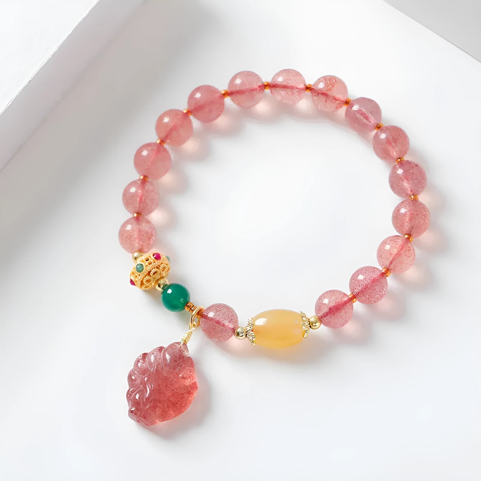 Women's crystal bracelet with polished strawberry quartz beads in nine tail fox colour design