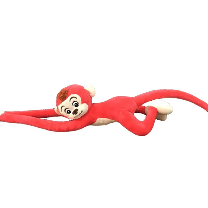 Long arm pink plush monkey toy hanging over a curtain rod as room decoration.