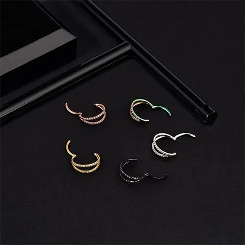 G23 titanium alloy nose ring with monoclinic diamond treatment in gold and steel colour on a grey background.