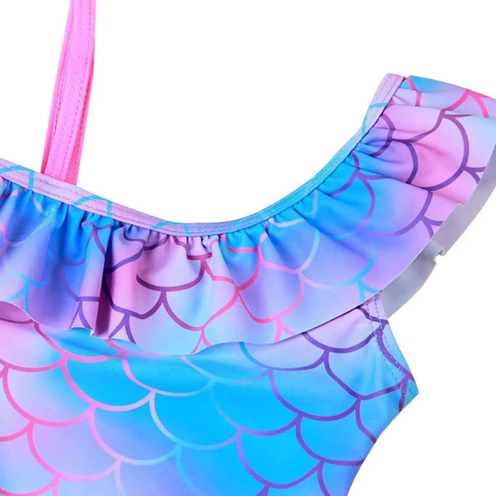Girls' one-piece swimsuit with cartoon scale print and flounced gradient design in high elasticity nylon.