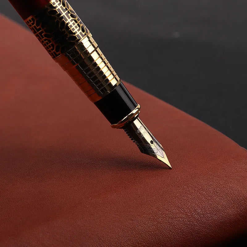 Metal fountain pen with imitation mahogany wood grain finish and 0.5mm nib on a desk setup