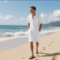 Linen blend short sleeve shirt and matching shorts beach suit set laid flat, shown in light blue colour.