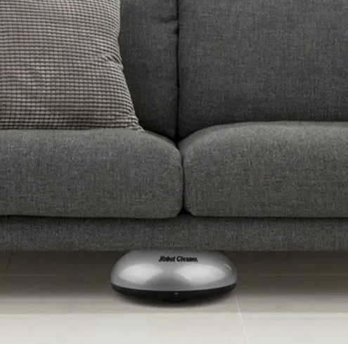 Silver automatic floor sweeping robot with 18cm diameter compact design