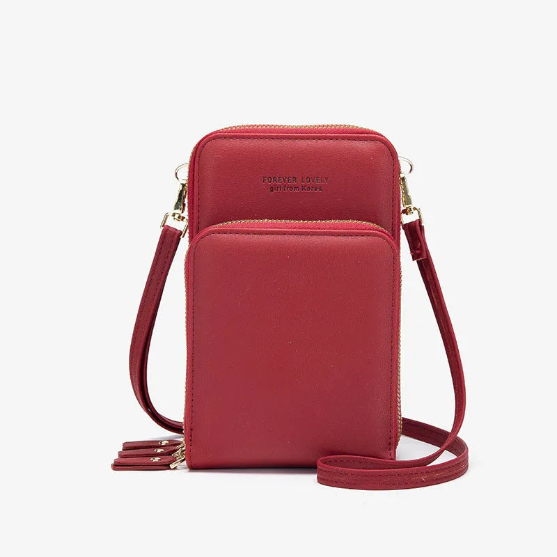 Green crossbody bag with tri-fold pockets and zipper closure on white background