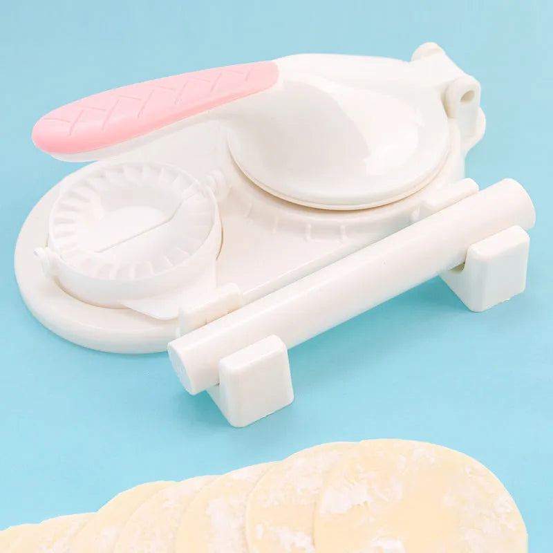 Plastic 3 in 1 dumpling maker with rolling pin and two props in white and green on a table