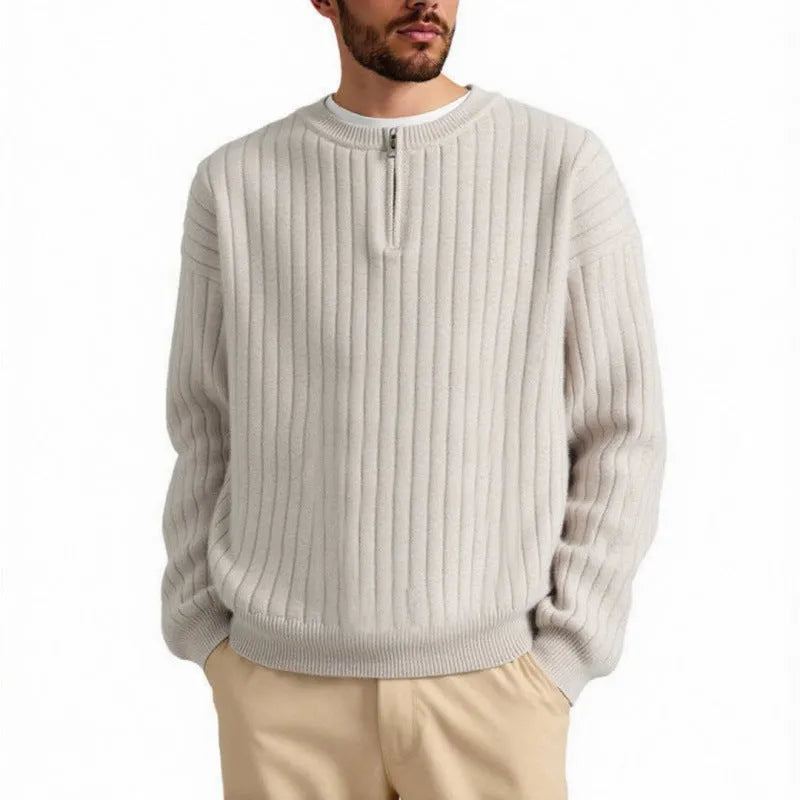 A grey men's loose fit half zip pullover sweater with a textured knit and long sleeves.