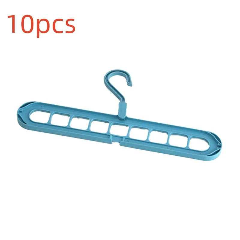 Green nine-hole plastic folding hanger with trousers organised vertically