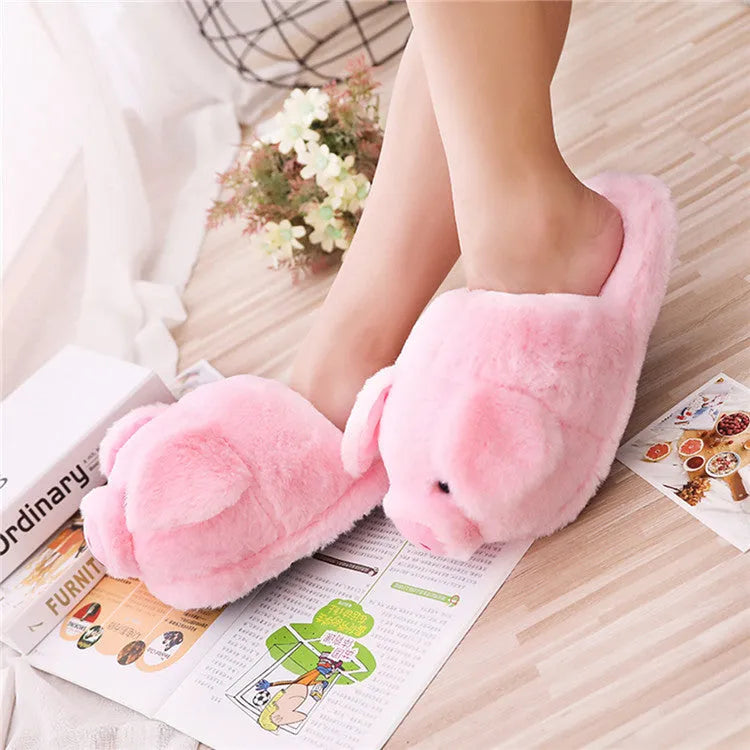 Pink adult pig slippers with short plush lining and a size chart showing international conversions.