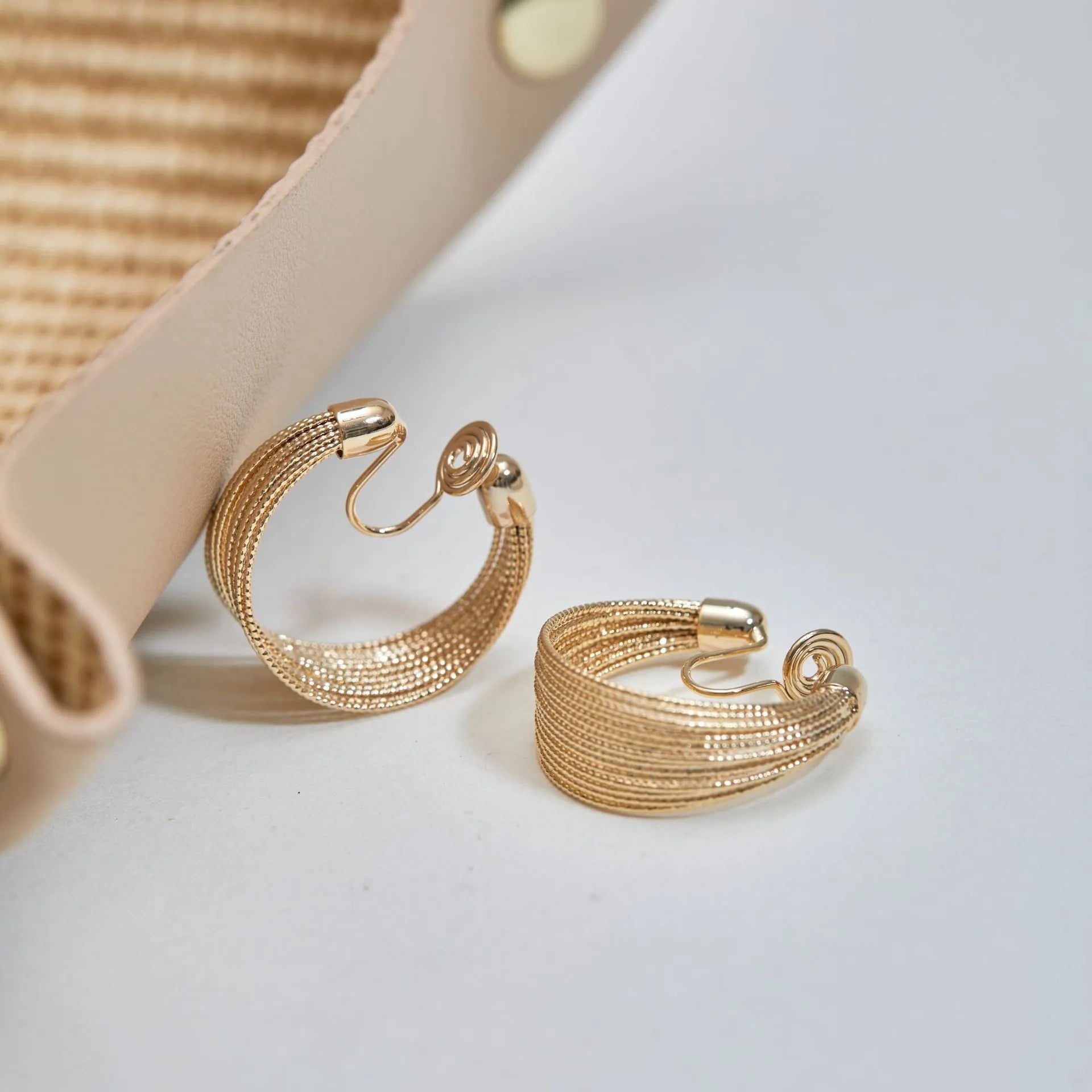 Geometric multi-layer copper earrings with silver or gold electroplated finish, available as studs or clips