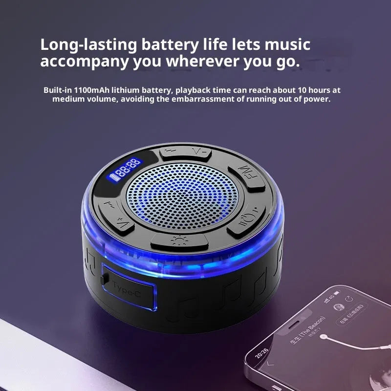 Waterproof Bluetooth speaker with large suction cup in black, mounted on bathroom tile