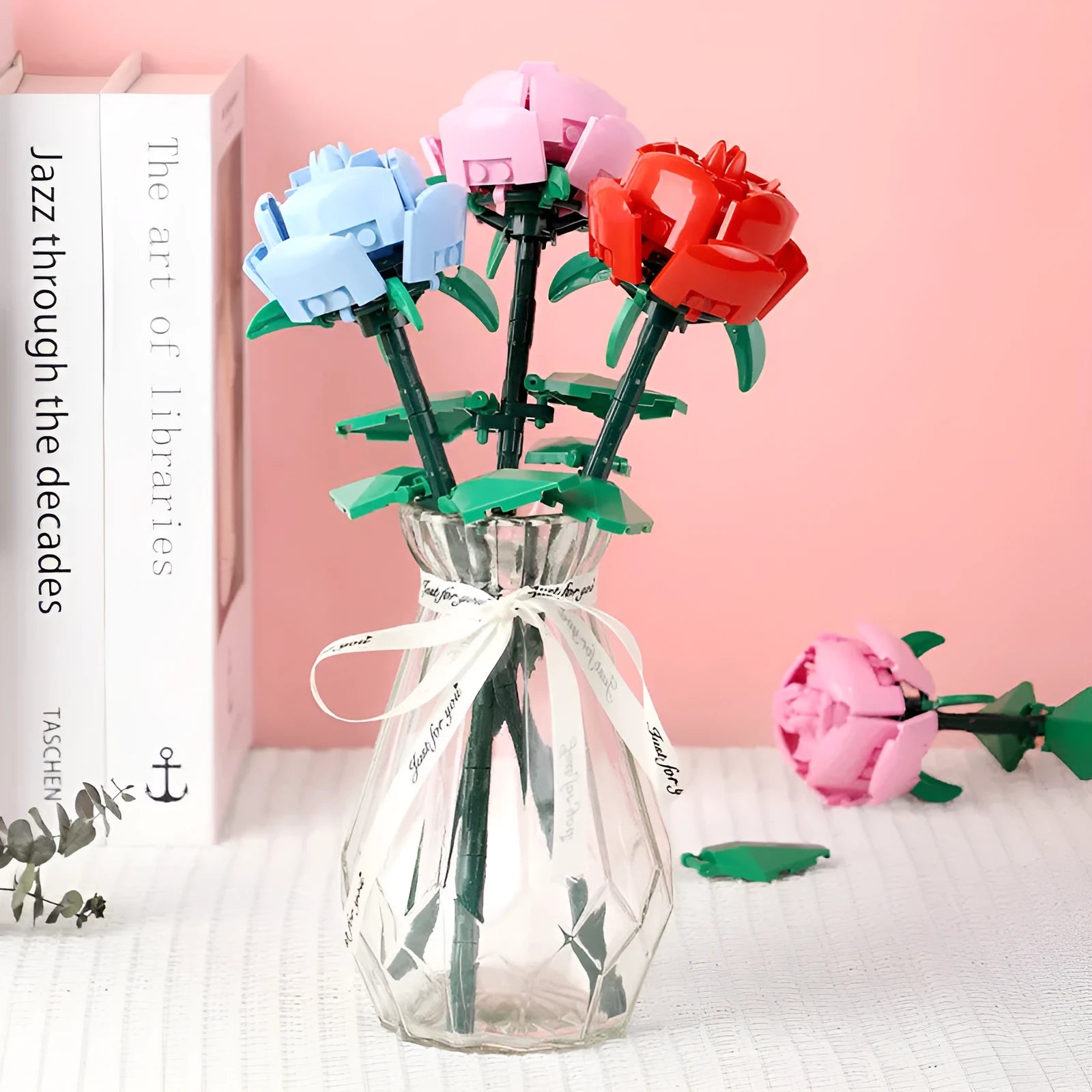 Rose assembled from small particle plastic building blocks in pink, red, or blue
