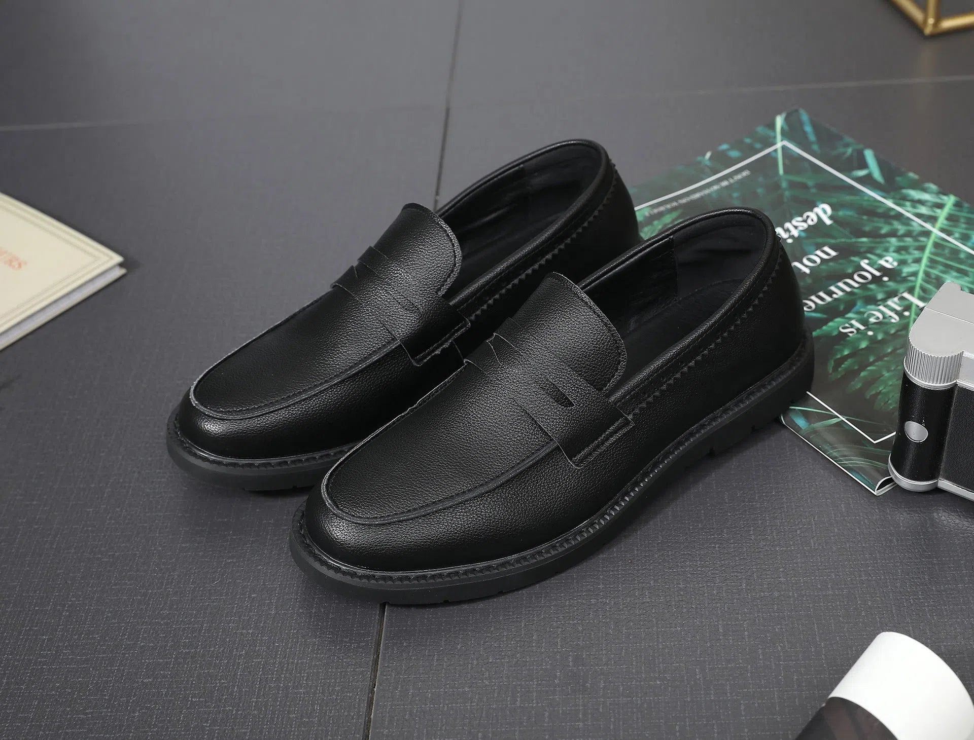 Men's black Korean retro slip-on driving shoes with microfiber upper and stitched detailing on white background
