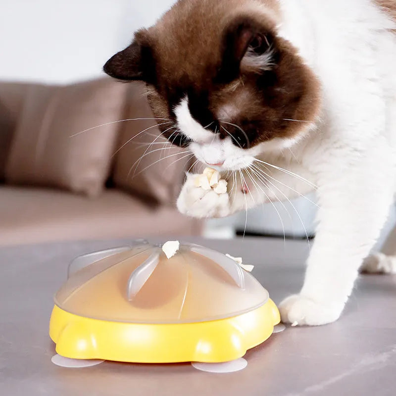 Yellow plastic cat entertainment plate with snack storage compartments and dispensing channels