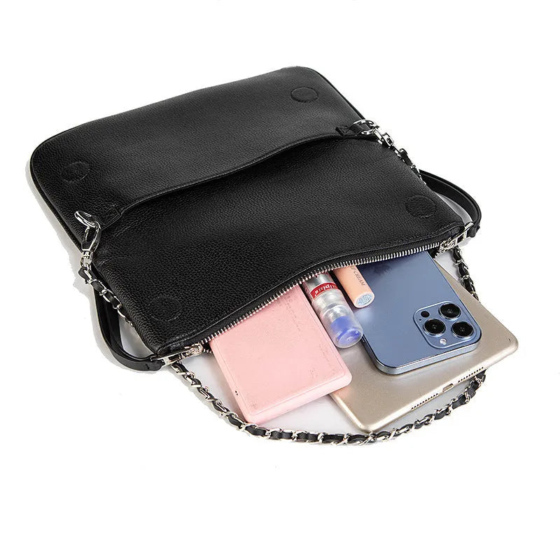 Women's black chain clutch bag with detachable shoulder strap showing interior zipper pocket and gold hardware details