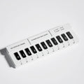 Black and white piano-shaped plastic parking sign measuring 148mm wide
