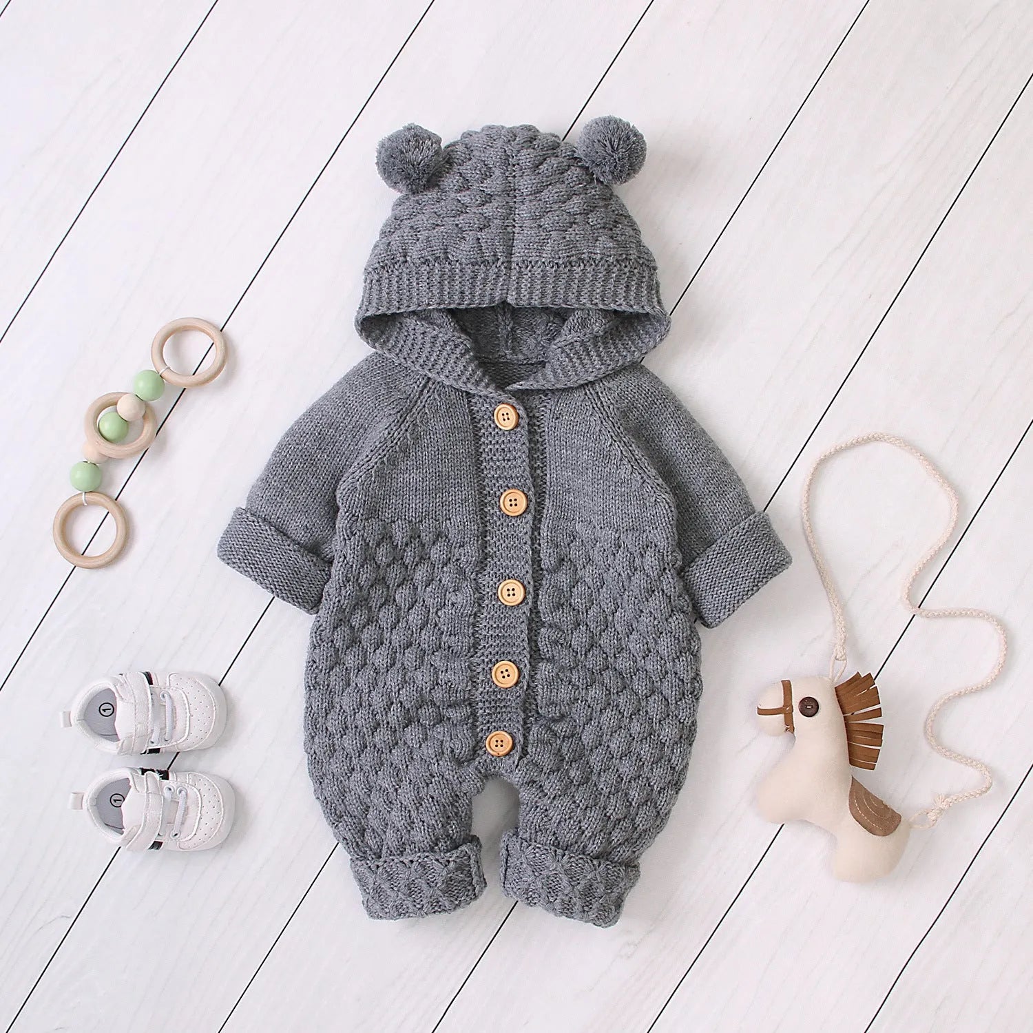 Baby knitted jumpsuit in blue, full-length with button front and hand flaps