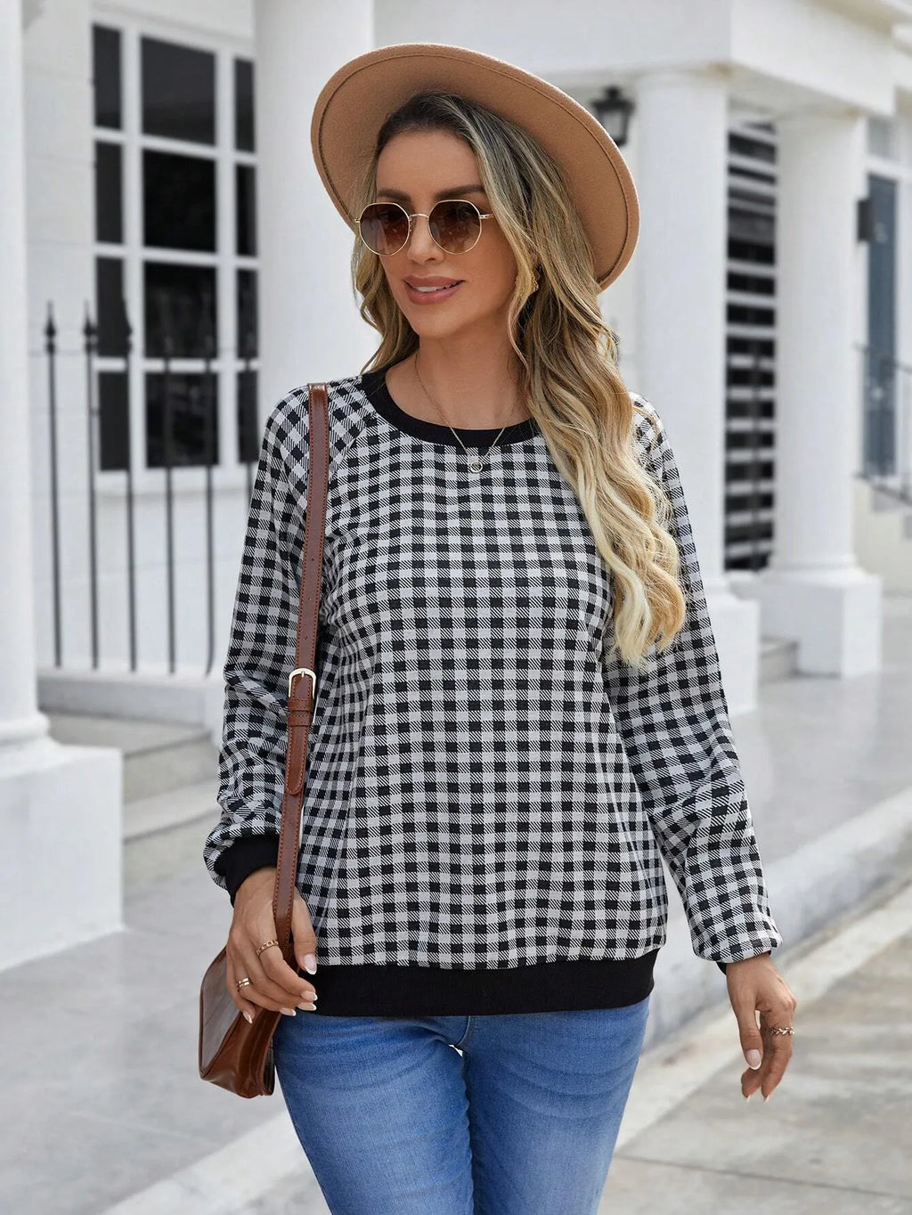 Black polyester pullover sweater with a plaid and printed stripe pattern, long sleeves.