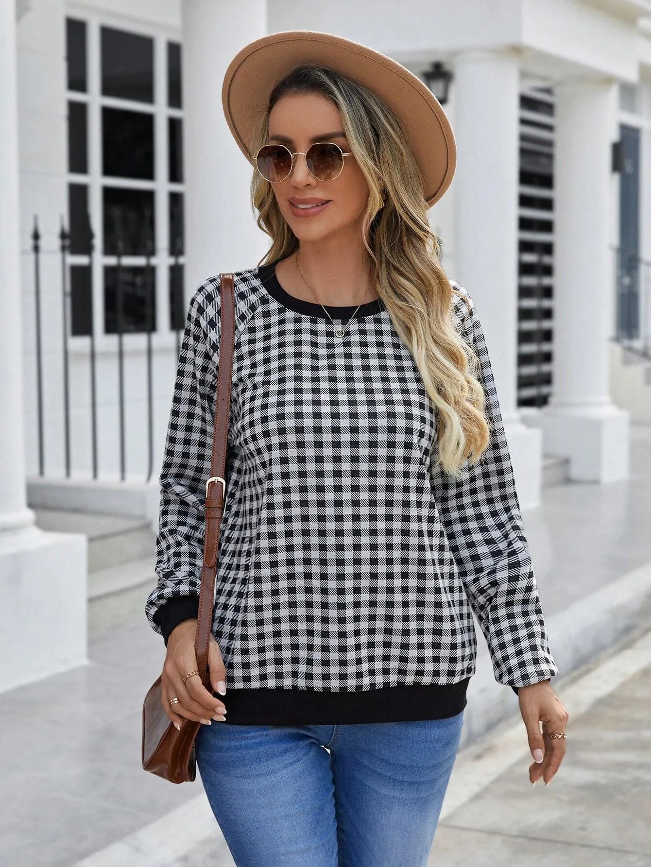 Black polyester pullover sweater with a plaid and printed stripe pattern, long sleeves.