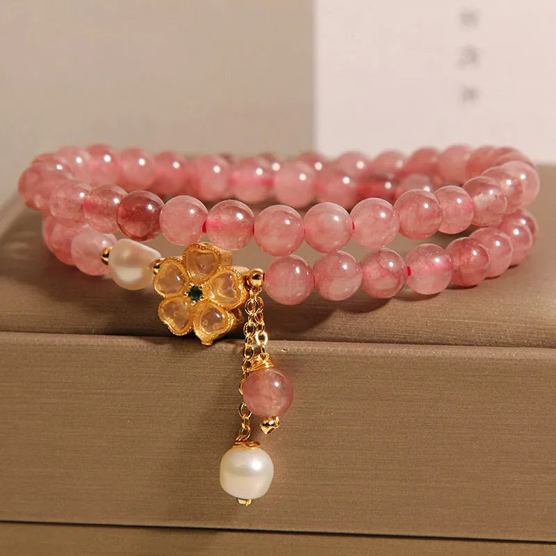 Women's twin four-leaf clover charm bracelet with strawberry quartz crystals and alloy inlay settings.